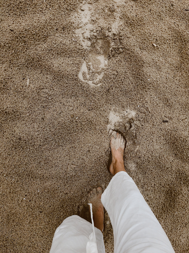 Person Walking on Sand